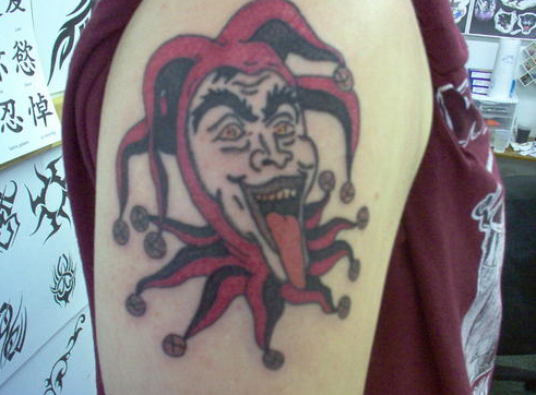 Color Ink Evil Jester Face Teasing Tattoo On Right Shoulder