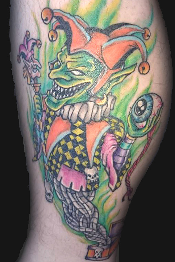 Colorful Evil Jester Holding Eye Tattoo By James Cook