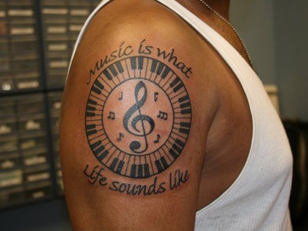 Cool Music Note In Piano Key Circle Tattoo On Left Shoulder