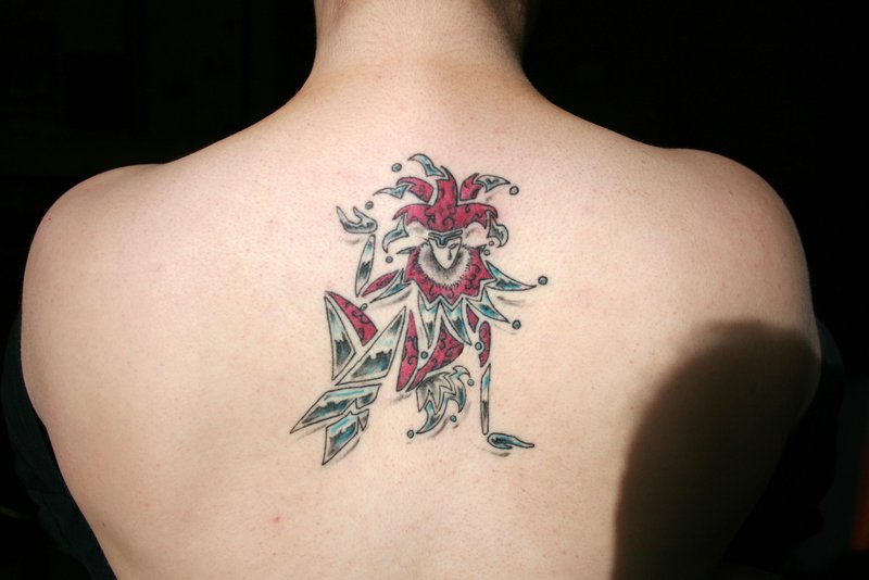 Cool Tribal Jester Color Tattoo On Upper Back By Jester Tattoo