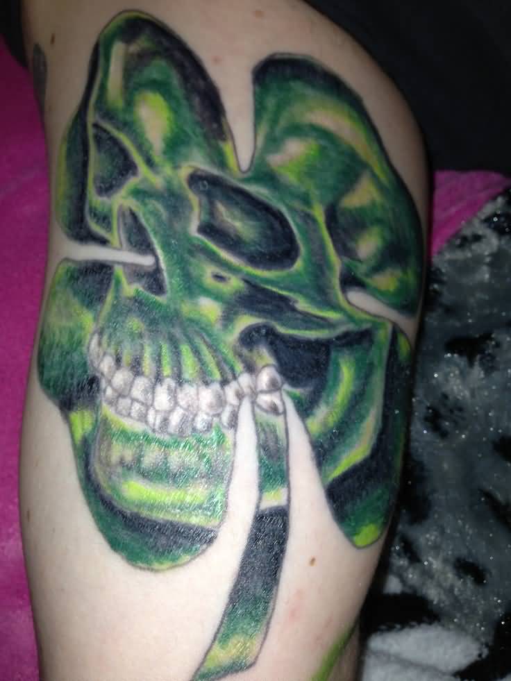 Creative Laughing Skull Picture In Shamrock Leaf Tattoo