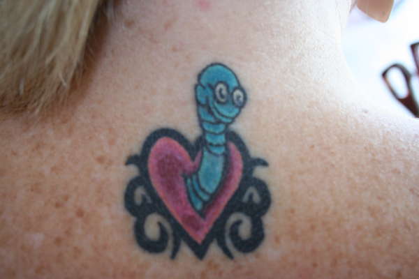 Cute Heart Worm Wearing Spectacles Tattoo On Upper Back