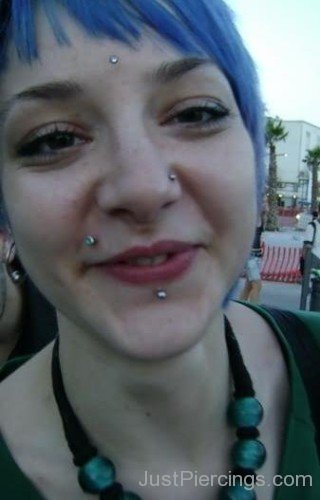 Cute Smiling Girl With Monroe, Labret And Third Eye Piercing