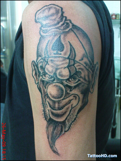 Grey Ink Evil Jester Head Tattoo On Left Half Sleeve