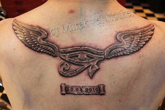 Grey Ink Horus Eye Having Wings Memorial Tattoo On Upper Back