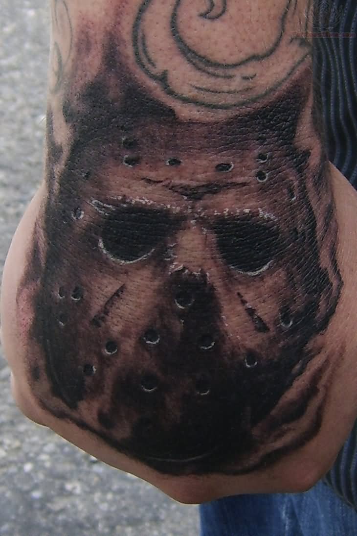 Grey Ink Jason Mask Tattoo On Hand