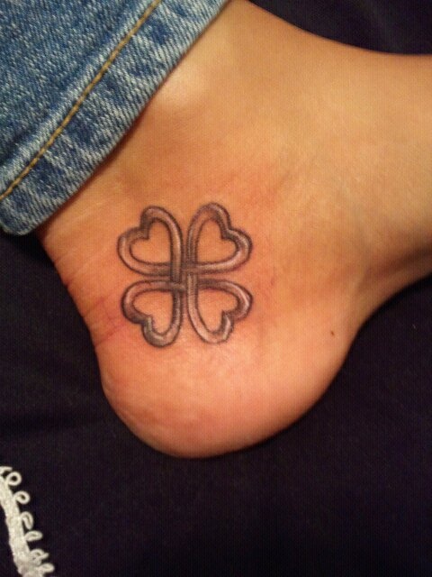 Grey Ink Small Celtic Four Leaf Shamrock Tattoo On Heel