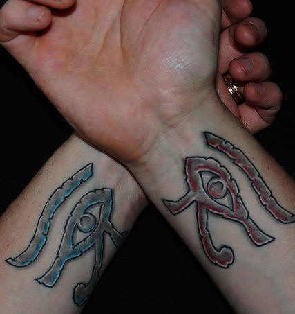 Impressive Different Colored Horus Eye Matching Couple Tattoos On Wrists