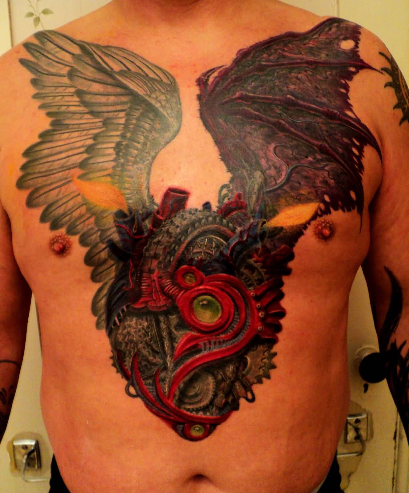 Incredible Mechanical Heart Having Wings Tattoo On Chest