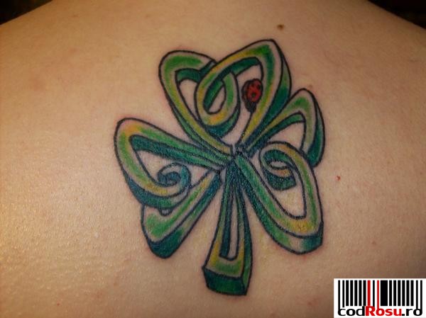 Ladybug On Celtic Shamrock Tattoo On Upper Back