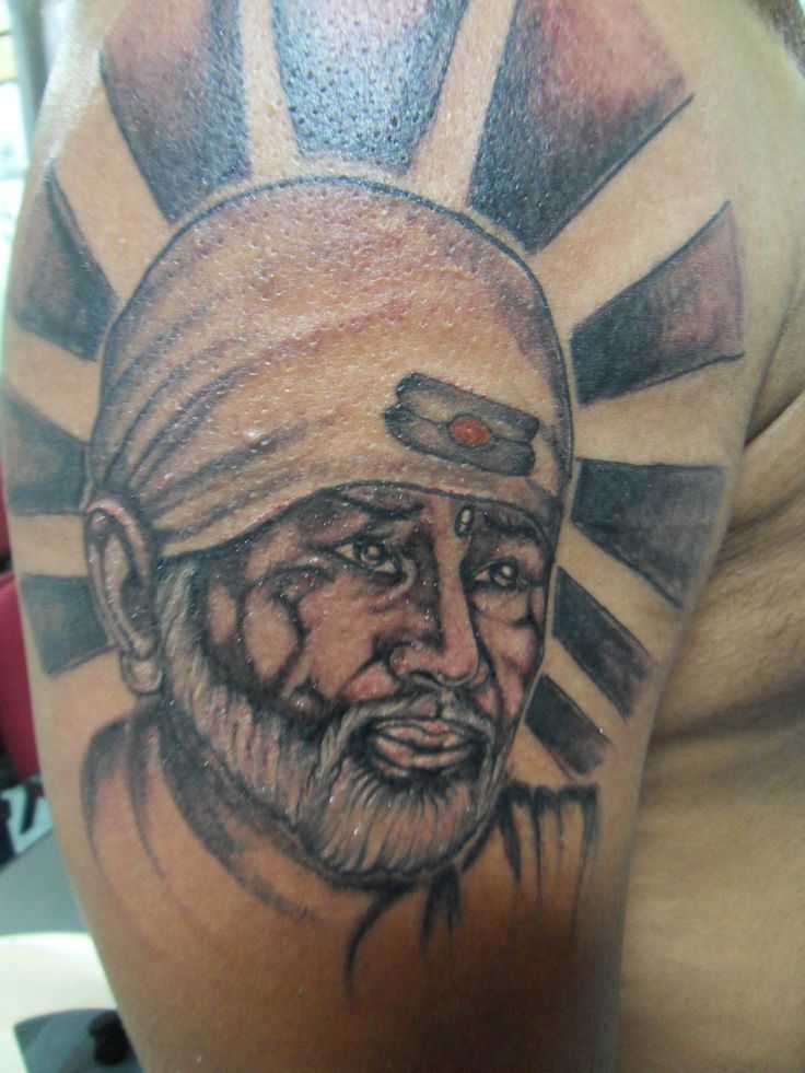 Large Sai Baba Face With Rays Tattoo On Left Half Sleeve