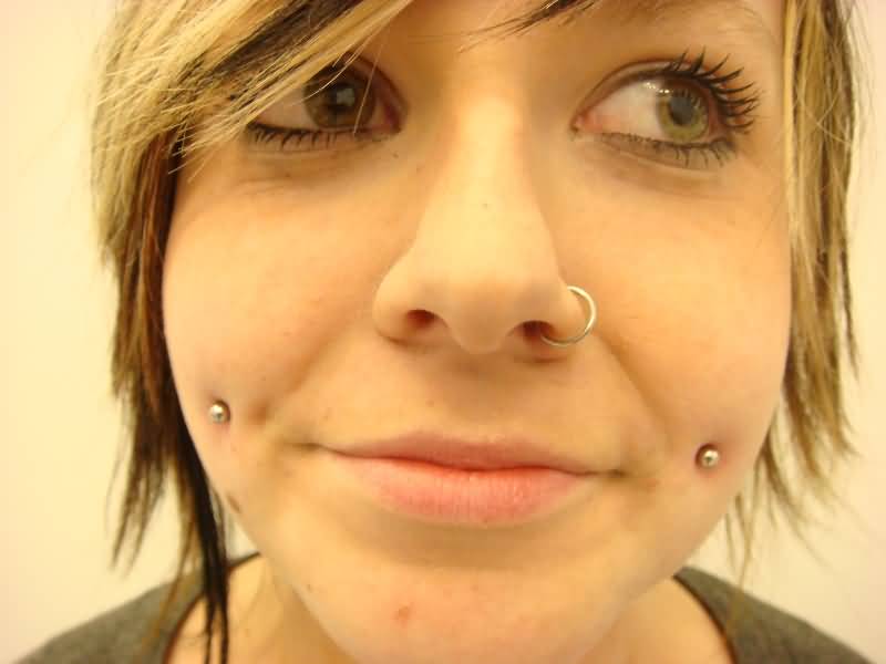 Left Nostril And Dimple Cheek Piercings