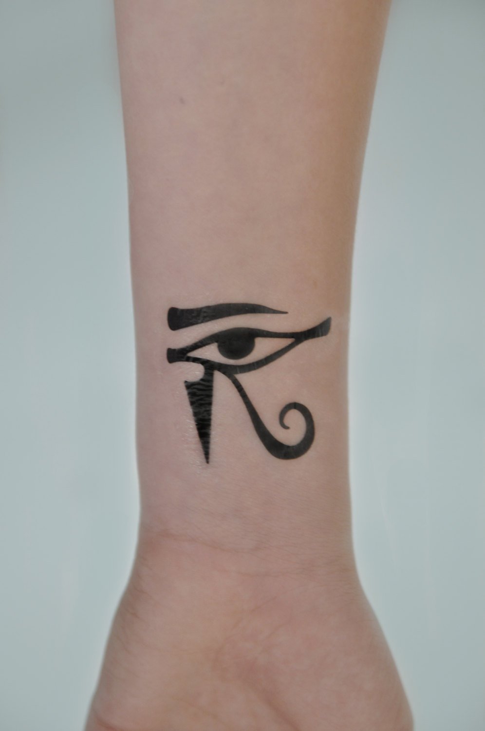 Lovely Dark Black Horus Eye Tattoo On Wrist