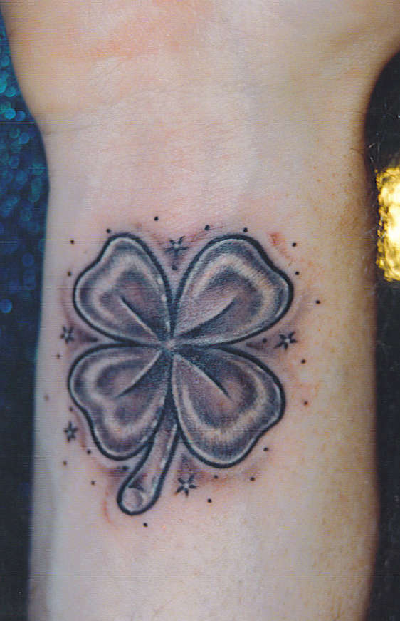 Lovely Grey Color Four Leaf Shamrock Tattoo On Wrist