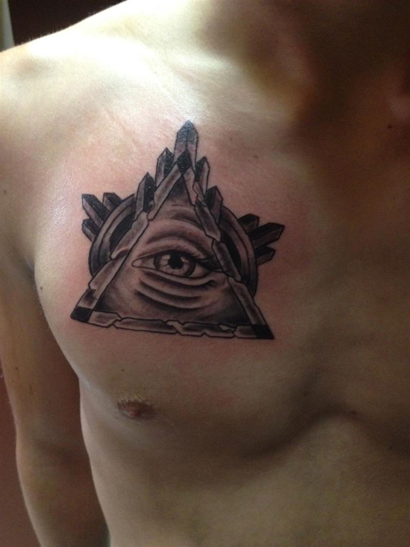 Lovely Grey Ink Triangle Eye With Crystals Tattoo On Left Chest