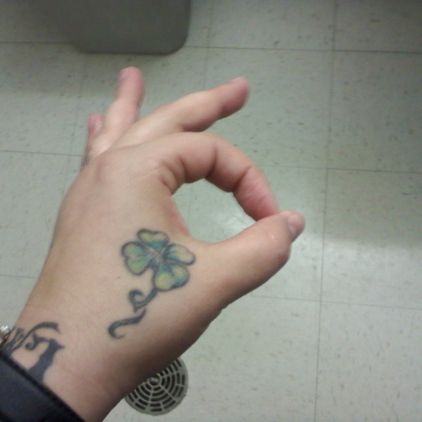 Lovely Small Four Leaf Shamrock Tattoo On Hand