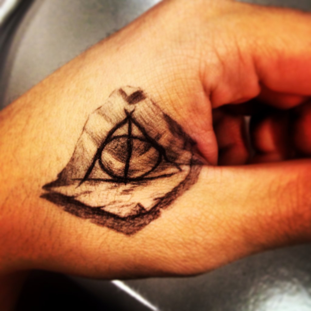 Nice Black And Grey 3D Hallows Tattoo On Hand