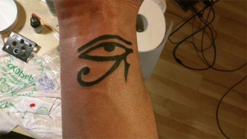 Nice Black Horus Eye Tattoo On Wrist
