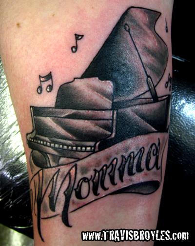 Nice Black Ink Color Grand Piano With Momma On Banner Tattoo