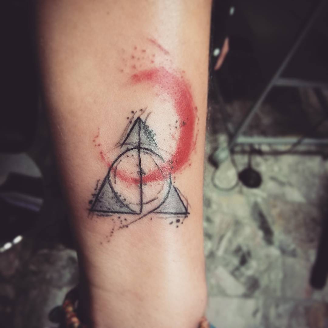 Nice Colored Deathly Hallows Tattoo On Forearm