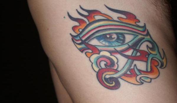Nice Colorful Horus Eye Flaming Tattoo