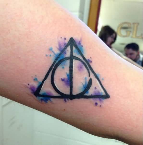 Nice Deathly Hallows Watercolor Tattoo On Bicep