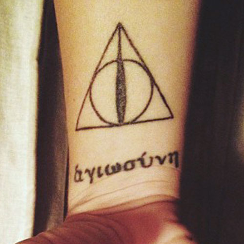 Nice Deathly Hallows With Lettering Tattoo On Wrist