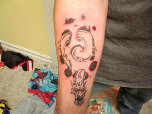 Nice Dragon Worm Ripped Skin Tattoo On Forearm