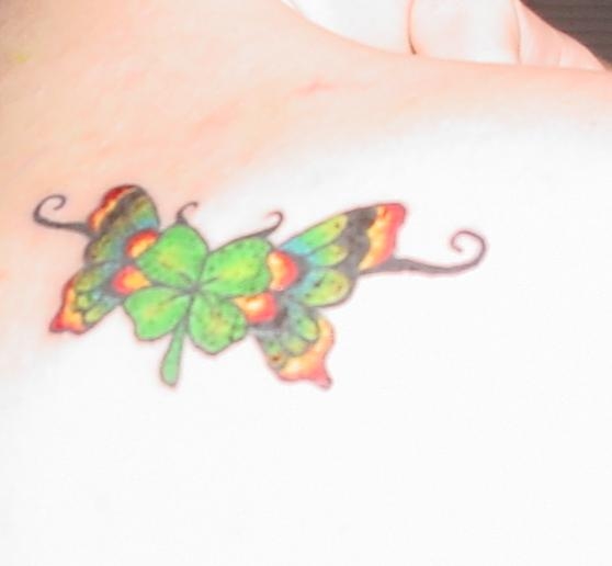 Nice Four Leaf Shamrock Having Butterfly Wings Tattoo