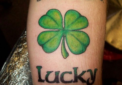 Nice Green Four Leaf Shamrock With Lucky Word Tattoo