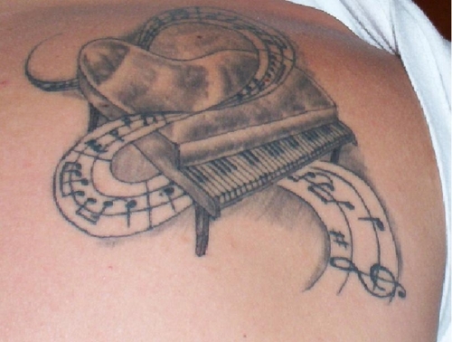 Nice Grey And Black Piano With Music Notes Tattoo