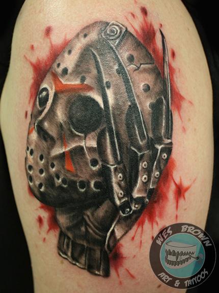 Nice Grey Color Jason Mask With Freddy Glove Tattoo On Left Shoulder