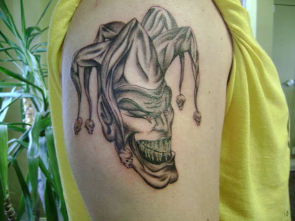 Nice Grey Ink Evil Jester Head Tattoo On Right Half Sleeve
