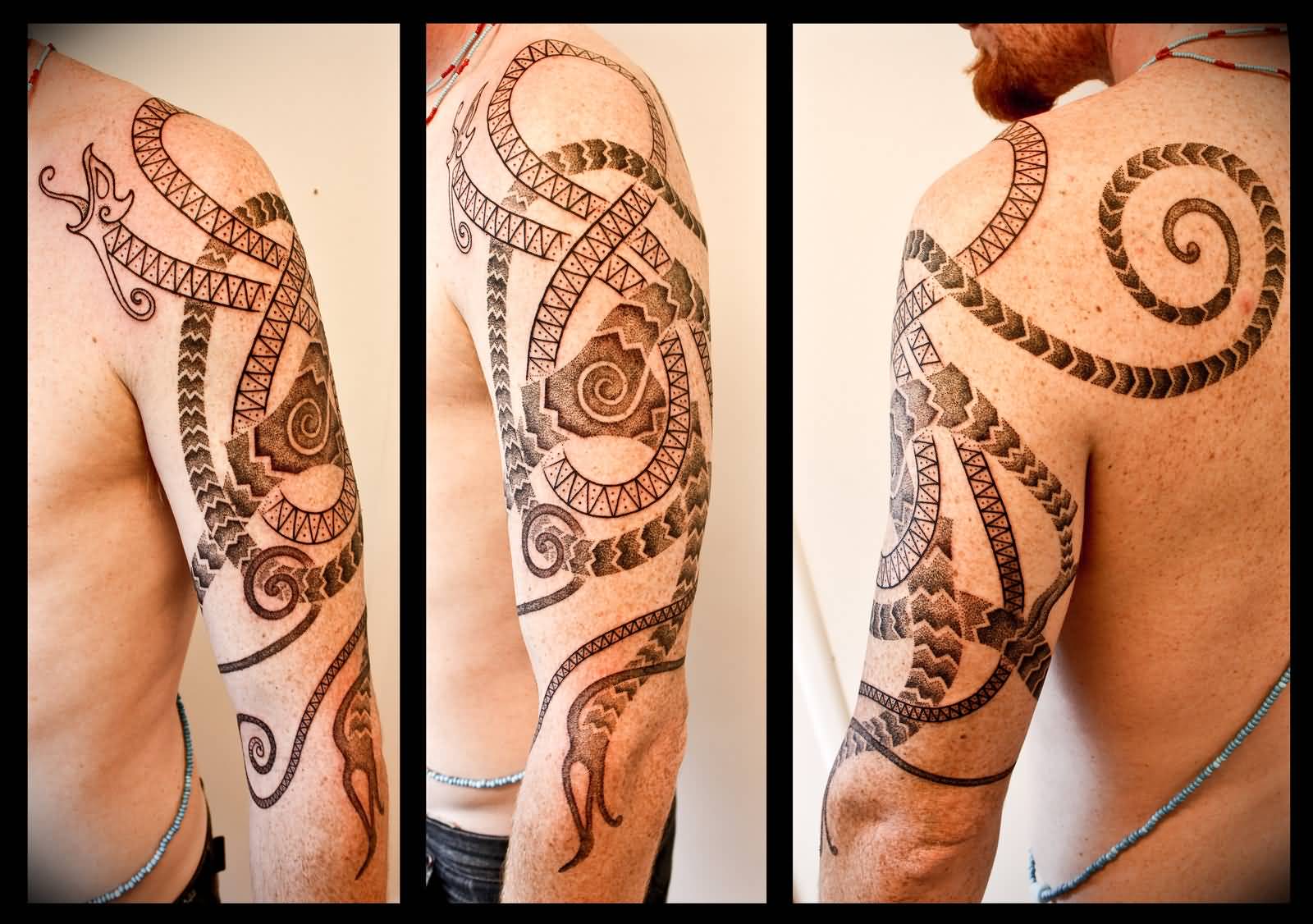 Nice Grey Urnes Style Worm Tattoo On Left Half Sleeve By Meatshop Tattoo