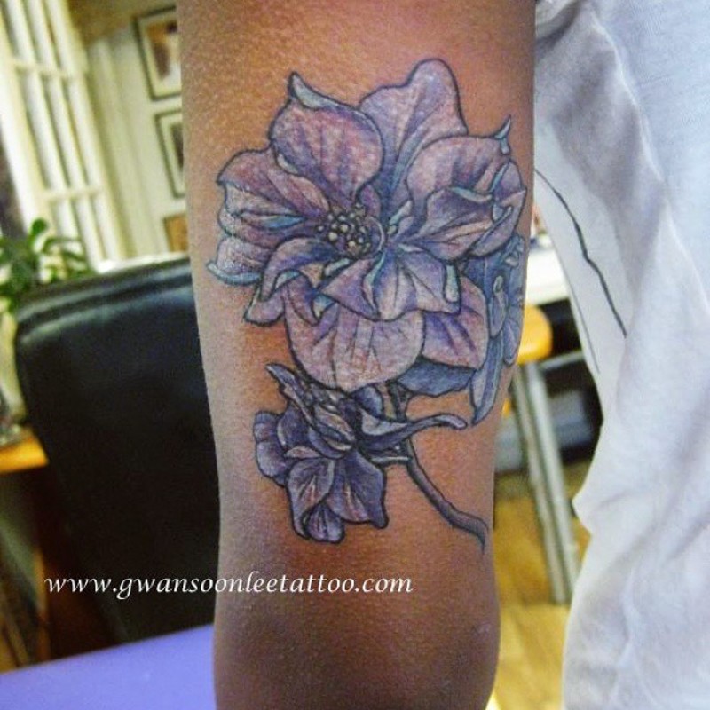 Nice Light Purple Iris Flowers Tattoo On Triceps