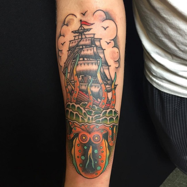 Nice Octopus And Sea Ship Traditional Tattoo On Forearm