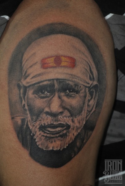 Nice Portrait Of Sai Baba In Circle Tattoo