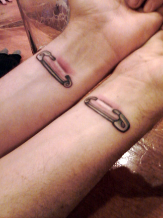 Nice Safety Pin Ripped Skin Matching Tattoo On Wrists