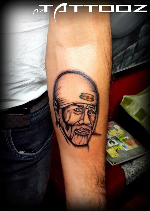 Nice Sai Baba Face Tattoo On Forearm
