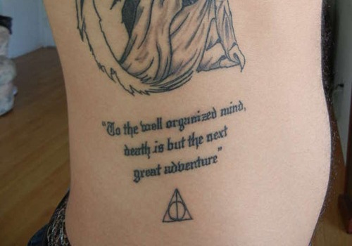 Nice Small Deathly Hallows With Quote Tattoo On Side Rib