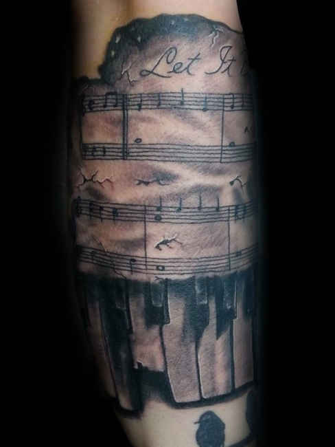 Outstanding Piano Keys With Music Notes Tattoo