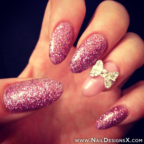 Pink Glitter Stiletto Nail Art With Accent Metallic 3D Bow Design