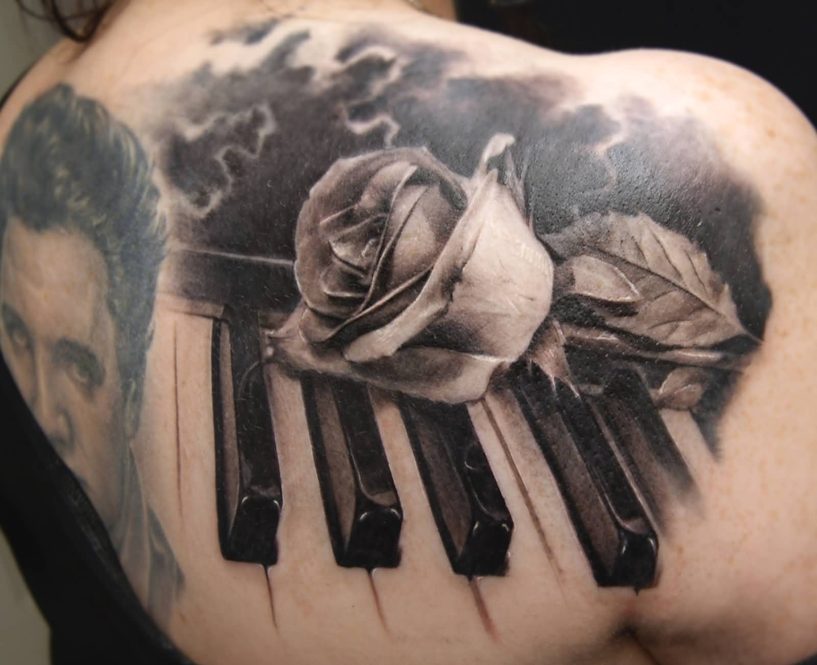 Realsitic Rose On Piano Keys Tattoo On Upper Back