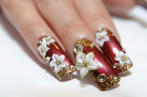 Red Nails With Gold Glitter And White Flowers 3D Nail Art