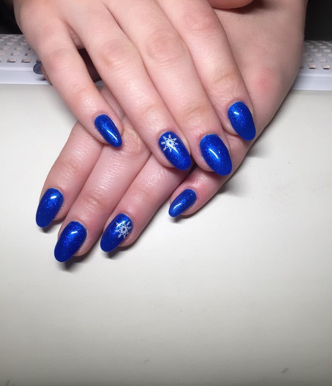 Royal Blue Nails With Accent Snowflakes Design Idea