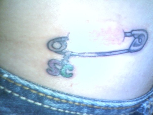 Safety Pin And SC Letters Tattoo