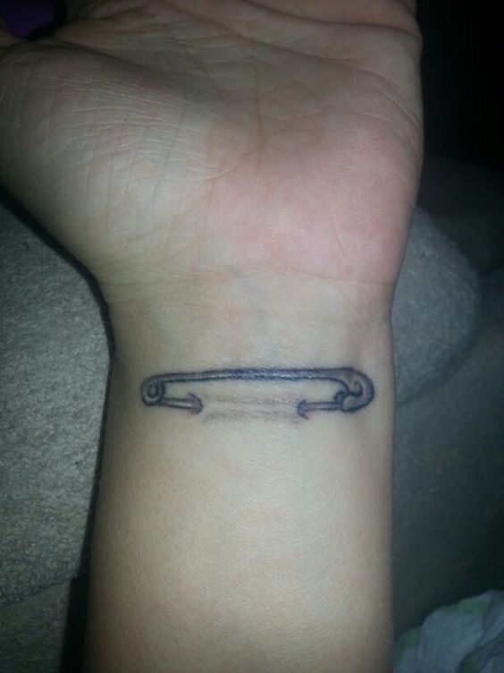 Safety Pin Ripped Skin Tattoo On Wrist