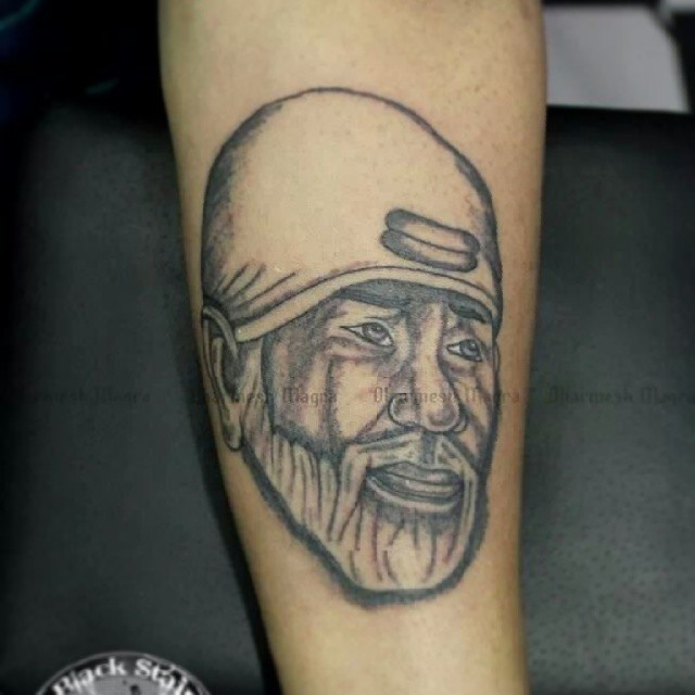 Sai Baba Face Tattoo On Forearm