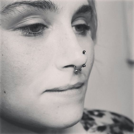 Septum And Rhino Piercing With Black Barbell