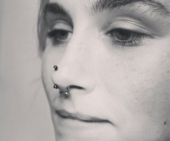 Silver Septum And Rhino Piercing With Black Barbell